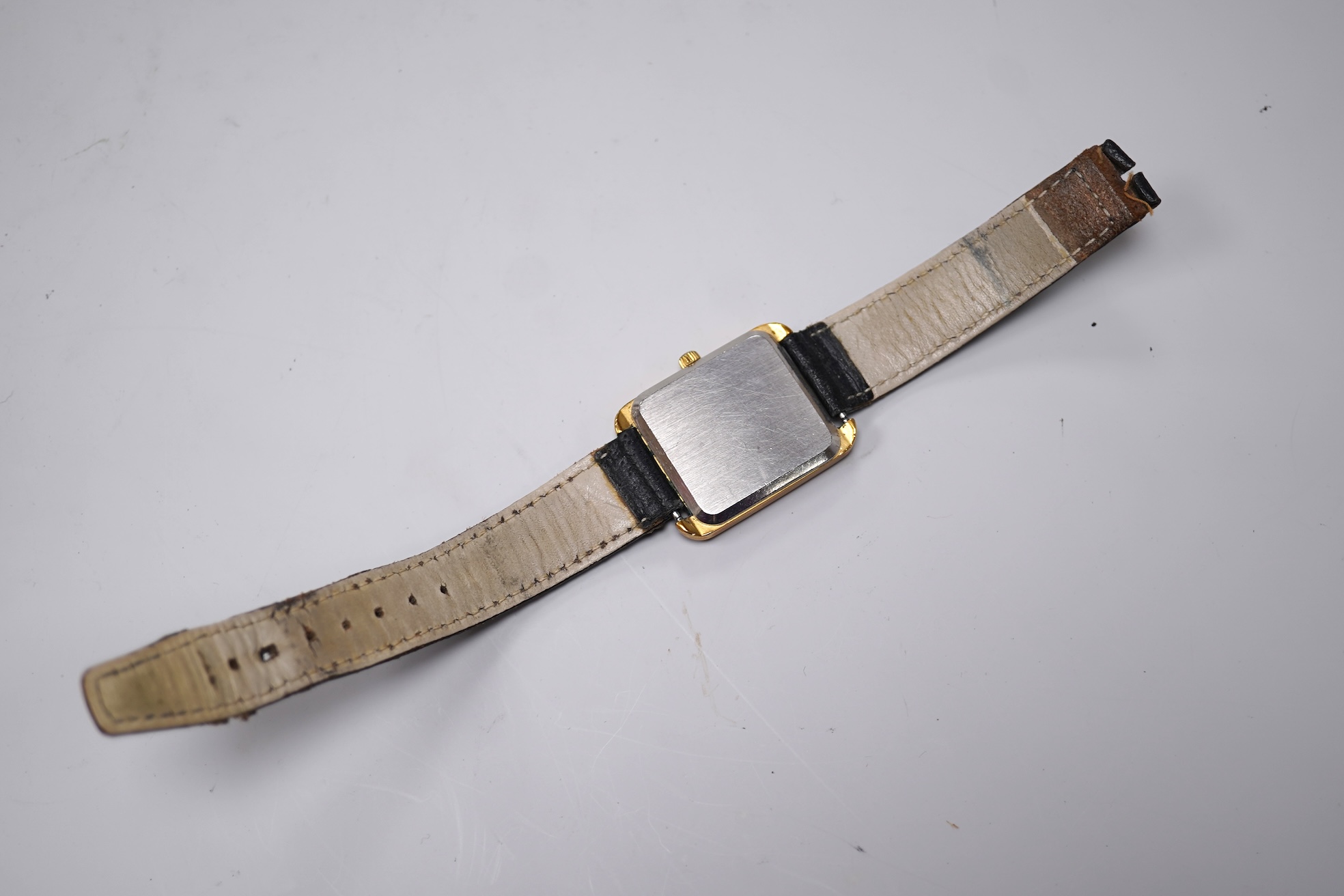 A gentleman's late 1970's steel and gold plated Omega De Ville quartz wrist watch, with rectangular dial and baton numerals, movement c.1330, case diameter 30mm, no buckle, box or papers.